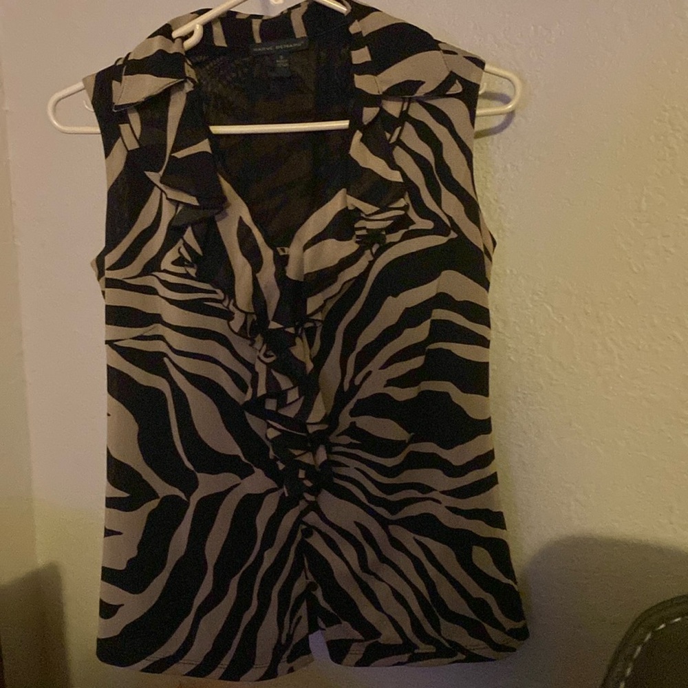 Sleeveless zebra print ruffle front blouse. Fully lined. Like new.